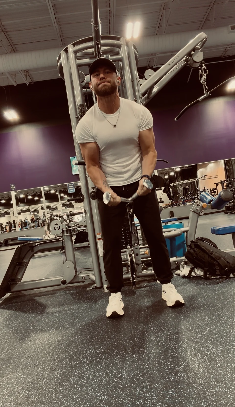 Nathan Wattier training with a cable machine at the gym